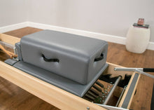 Load image into Gallery viewer, CenterLine Sitting Box placed on a CenterLine Reformer. | caption::CenterLine Sitting Box placed on CenterLine Reformer.