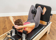 Load image into Gallery viewer, Reformer workout using The Aligner with a Jumpboard