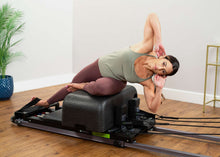 Load image into Gallery viewer, padded footstrap for reformer exercises in use | caption::Extra Long Footstrap on Metro IQ Reformer