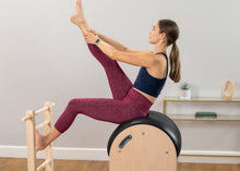 Load image into Gallery viewer, Woman exercising on Pilates ladder barrel