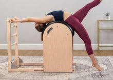 Load image into Gallery viewer, Woman stretching her back on the Pilates Ladder Barrel