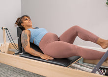 Load image into Gallery viewer, pregnant woman using pilates angle on reformer