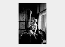 Load image into Gallery viewer, Joseph Pilates in black and white performing exercise. | caption::The Barrel