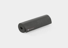 Load image into Gallery viewer, A rolled-up black mini mat for Pilates or yoga.