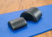 Load image into Gallery viewer, Small and large black half-cylinder cushions.