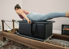 Load image into Gallery viewer, Woman using Large Sitting Box for Pilates exercises.