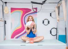 Load image into Gallery viewer, Woman holding a stack of Pilates exercise cards tailored for Cadillac Pilates.
