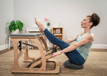 Load image into Gallery viewer, Woman working out with a Balansit cushion and an EXO chair.