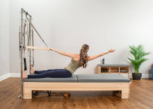 Load image into Gallery viewer, Student on CenterLine Reformer with Tower and Mat