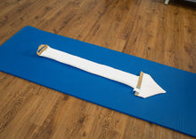 Load image into Gallery viewer, White SmartSpine cushion placed neatly on a blue exercise mat.