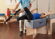 Load image into Gallery viewer, Balanced Body Sitting Box Riser in-use photo | caption:Tall Sitting Box Riser shown with Trapeze Table