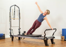Load image into Gallery viewer, The Allegro reformer itself offers a wide range of exercises including leg presses, arm exercises, and abdominal exercises.