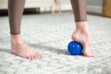 Load image into Gallery viewer, Soft-Spike Massage Ball in use - blue
