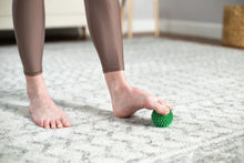 Load image into Gallery viewer, Soft-Spike Massage Ball in use - green
