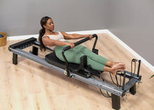 Load image into Gallery viewer, using the infinity footbar on the allegro nextgen reformer
