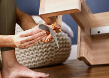 Load image into Gallery viewer, Women applying Non-skid strips for wood equipment to a reformer
