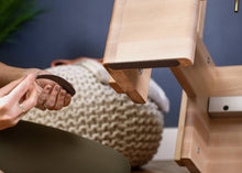 Load image into Gallery viewer, Women applying Non-skid strips for wood equipment to a reformer
