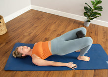 Load image into Gallery viewer, Bridging on Mat using The Aligner to correct leg postion.
