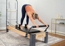 Load image into Gallery viewer, Pilates professional exercises on Rialto Reformer with tower
