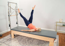 Load image into Gallery viewer, Pilates Studio Reformer with tower mat in use
