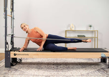 Load image into Gallery viewer, Pilates professional doing leg work Rialto Reformer with tower
