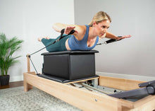 Load image into Gallery viewer, Woman using Large Sitting Box for Pilates exercises - on balanced body reformer
