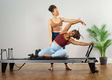 Load image into Gallery viewer, pregnant woman doing pilates on balanced body reformer
