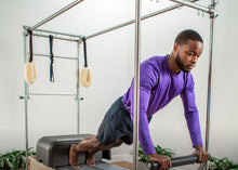 Load image into Gallery viewer, Man using the reformer trapeze combination | caption::Shown in Storm Upholstery
