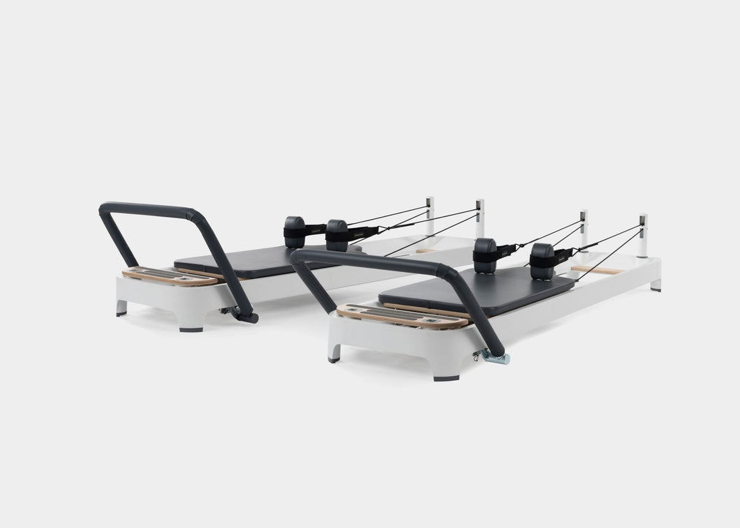 A photo of the Allegro 2 Pilates Reformer showing both the carbon fiber footbar and the steel footbar options. | caption::Carbon Fiber Footbar, Steel Footbar