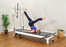 Load image into Gallery viewer, Woman targeting lower body while using the Allegro 2 Reformer Tower of Power.
