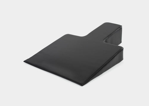 Black Pilates wedge for improved posture.