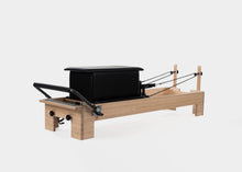 Load image into Gallery viewer, Black large sitting box positioned on a Pilates reformer.
