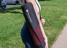 Load image into Gallery viewer, Woman carrying a stylish Pilates tote bag.

