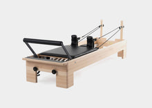 Load image into Gallery viewer, Side view of a fully set up Pilates Studio Reformer.
