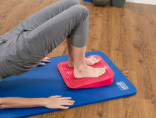 Load image into Gallery viewer, Inflatable Wedge being used by a student. This versatile prop helps to improve posture and alignment during exercises.
