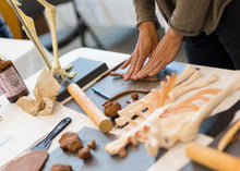 Load image into Gallery viewer, Woman sculpting with plastaline, displaying anatomy toolkit.
