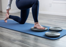 Load image into Gallery viewer, Woman kneeling on a Rotator Disc for precision rotation.
