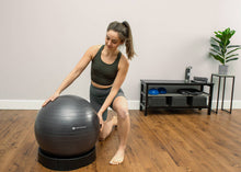 Load image into Gallery viewer, Woman holding a Deluxe Fitness Ball
