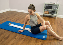 Load image into Gallery viewer, Woman using a white SmartSpine on blue Sissel gym mat.
