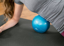 Load image into Gallery viewer, Woman stretching her ribs using an Eric Franklin Air Ball.

