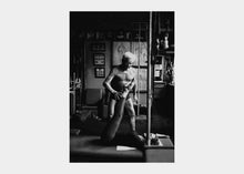 Load image into Gallery viewer, Classic photograph of Joseph Pilates instructing a Pilates session | caption::Client and Mat
