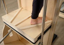 Load image into Gallery viewer, High-back Wunda Chair, a specialized Pilates equipment designed for a variety of seated and standing exercises.
