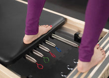 Load image into Gallery viewer, A zoomed-in snapshot showcasing the craftsmanship of signature springs on a Pilates reformer.
